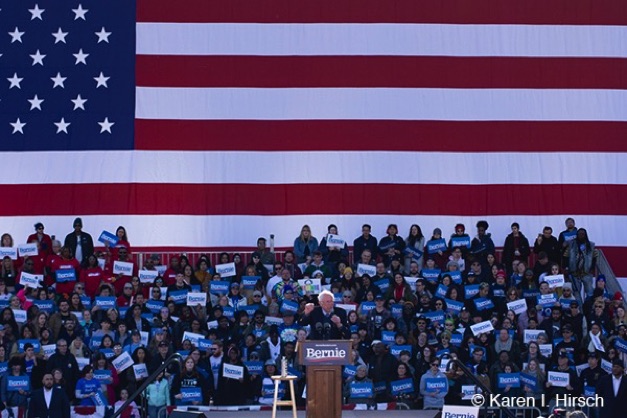 Huge American flag is backdrop where Bernie Sanders talks